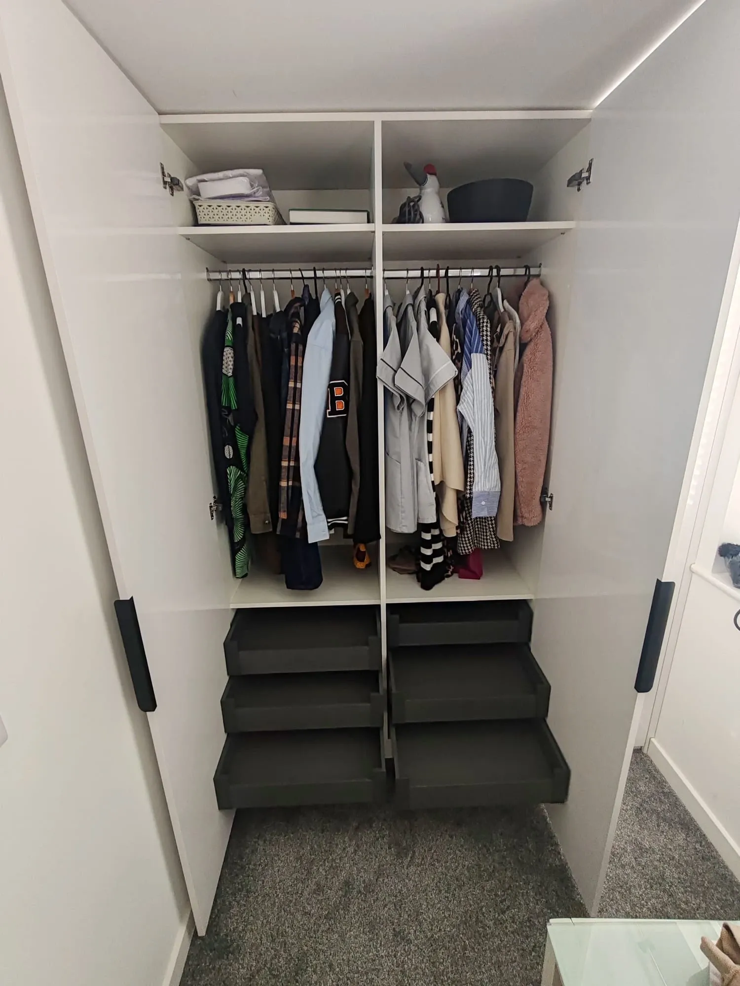 Stylish closet with neatly arranged clothes and shoes on shelves, demonstrating efficient storage solutions